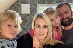 Single room ventilator wall-mounted in a home office, shown in a residential setting with family present.